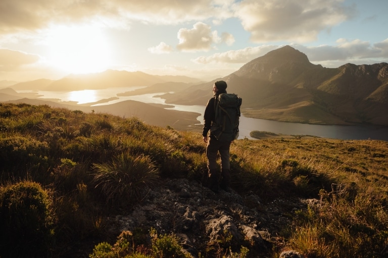 Hiker exploring Bathurst Harbour in Southwest National Park © Jason Charles Hill