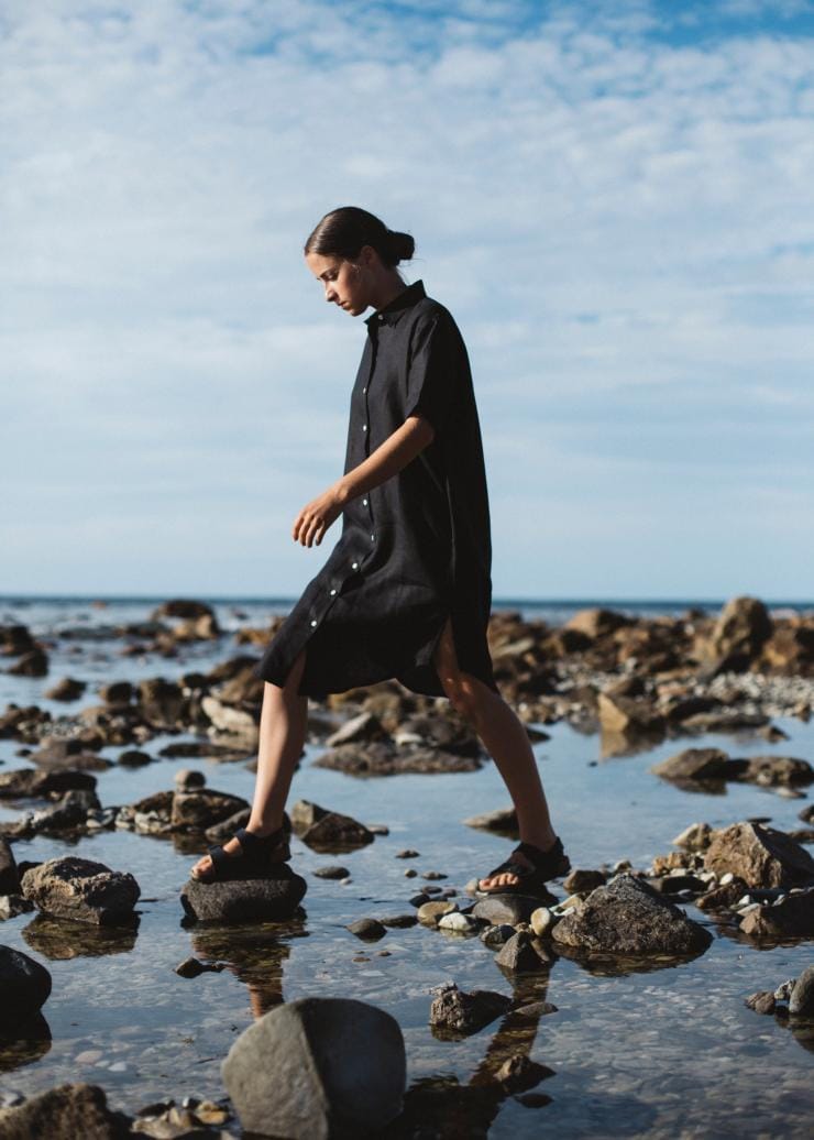 Woman walking over rock pools wearing clothing by Good Studios in Adelaide © Bing Rowland