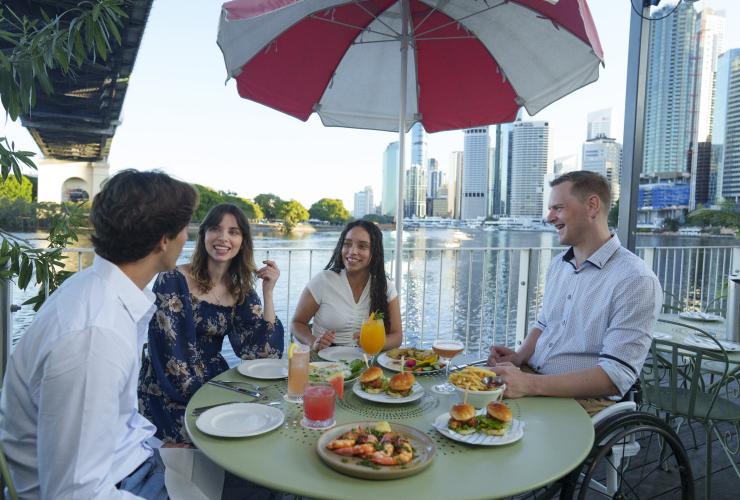 Tables of diners next to the Brisbane River at the Howard Smith Wharves in Brisbane © Tourism and Events Queensland