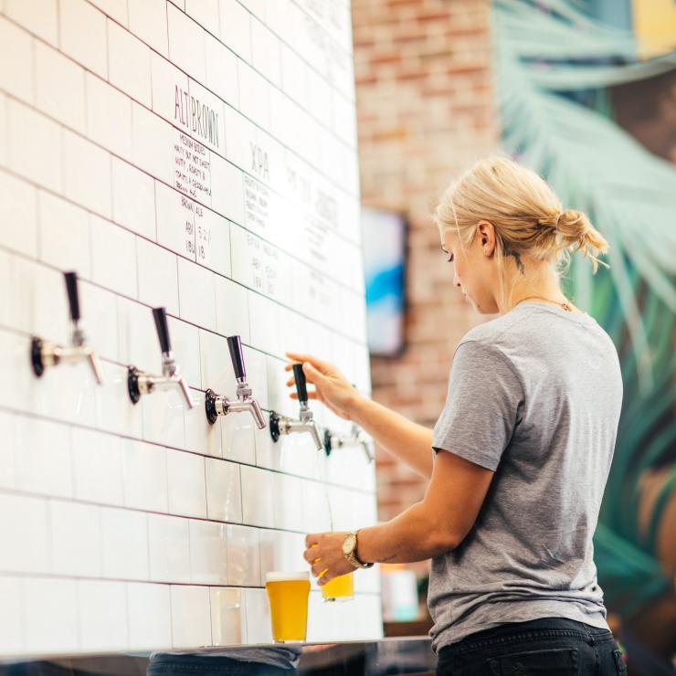 Girl pouring beer from tap at Balter Brewing © Balter Brewing