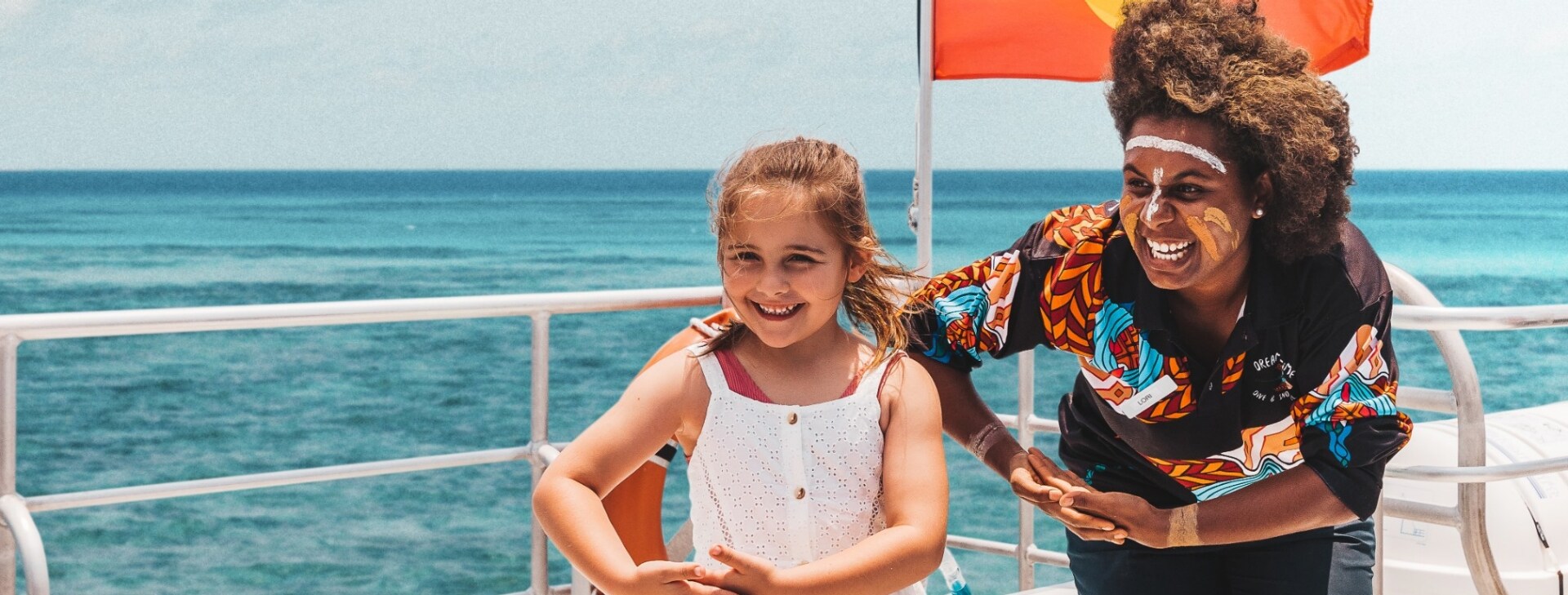 Children posing with an Aboriginal guide on board a Dreamtime Dive and Snorkel tour