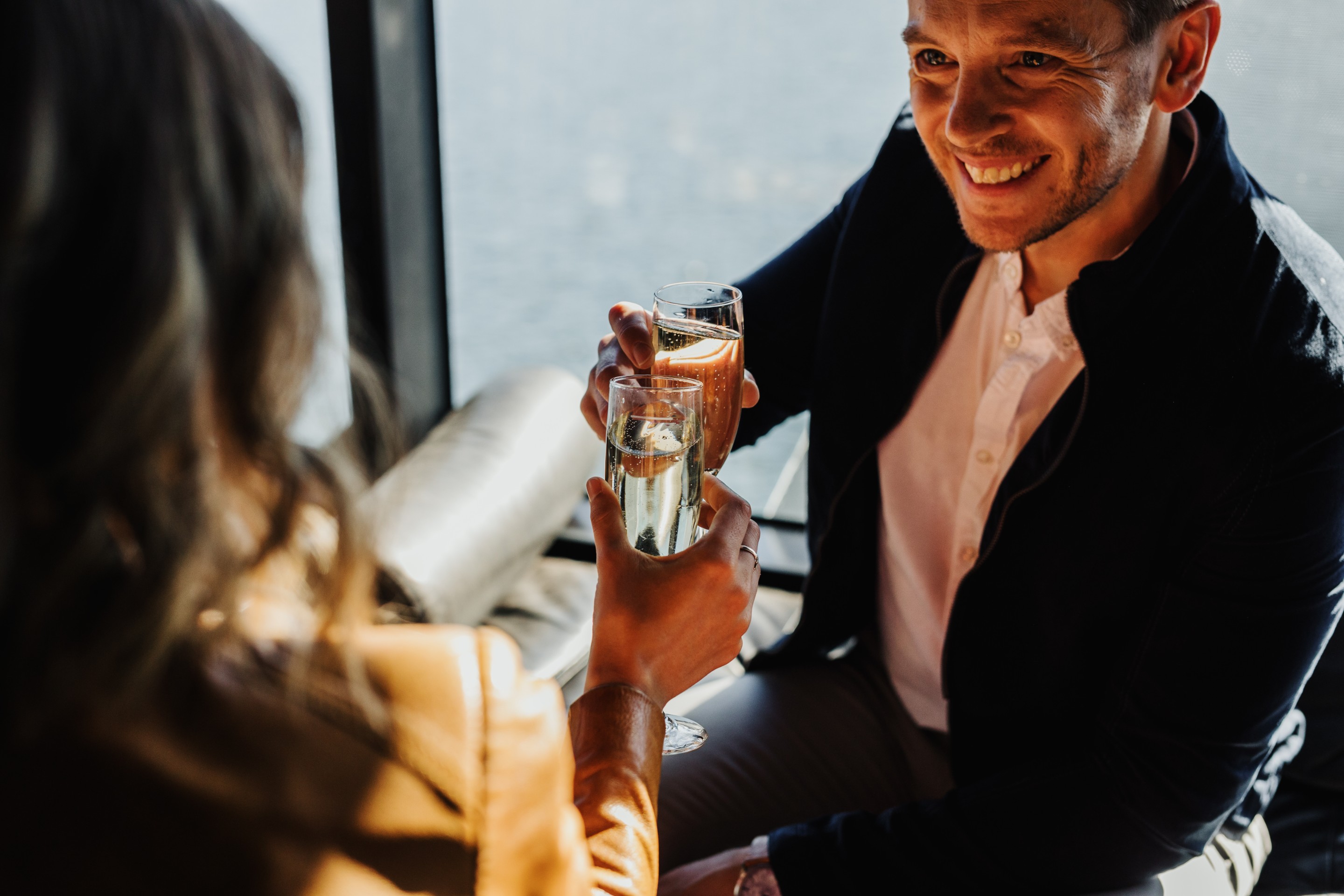 Couple enjoying champagne aboard the MR-1 ferry to MONA in Hobart © Adam Gibson