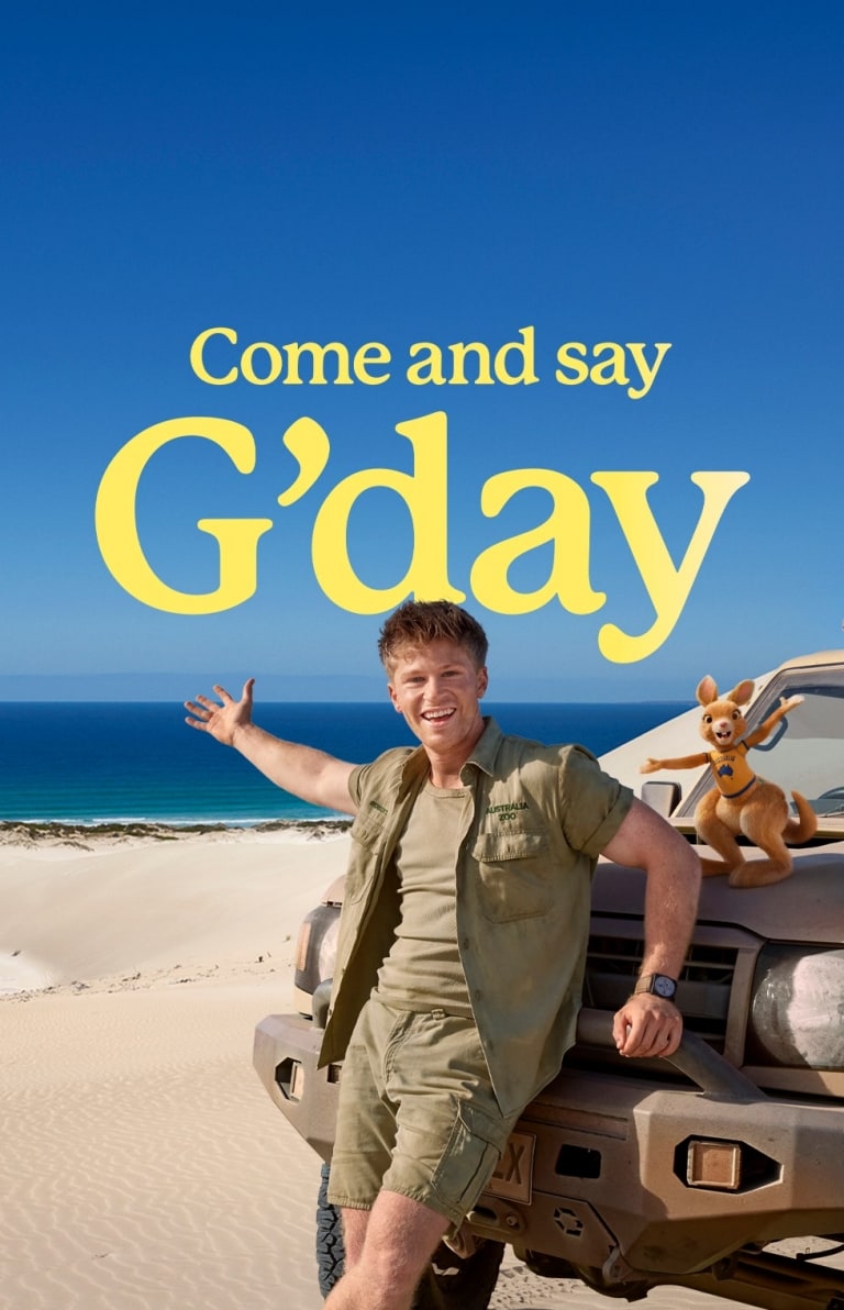 Come and say G'day, Robert Iriwn leaning on a 4WD on the beach in Port Lincoln, South Australia © Tourism Australia