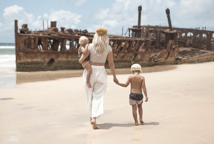 Family looking at S.S. Maheno on K’gari, Queensland © Tourism and Events Queensland