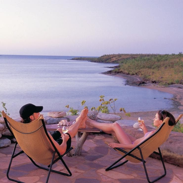 Couple se détendant au coucher du soleil à Faraway Bay, sur la côte nord-est du Kimberley © Tourism Western Australia