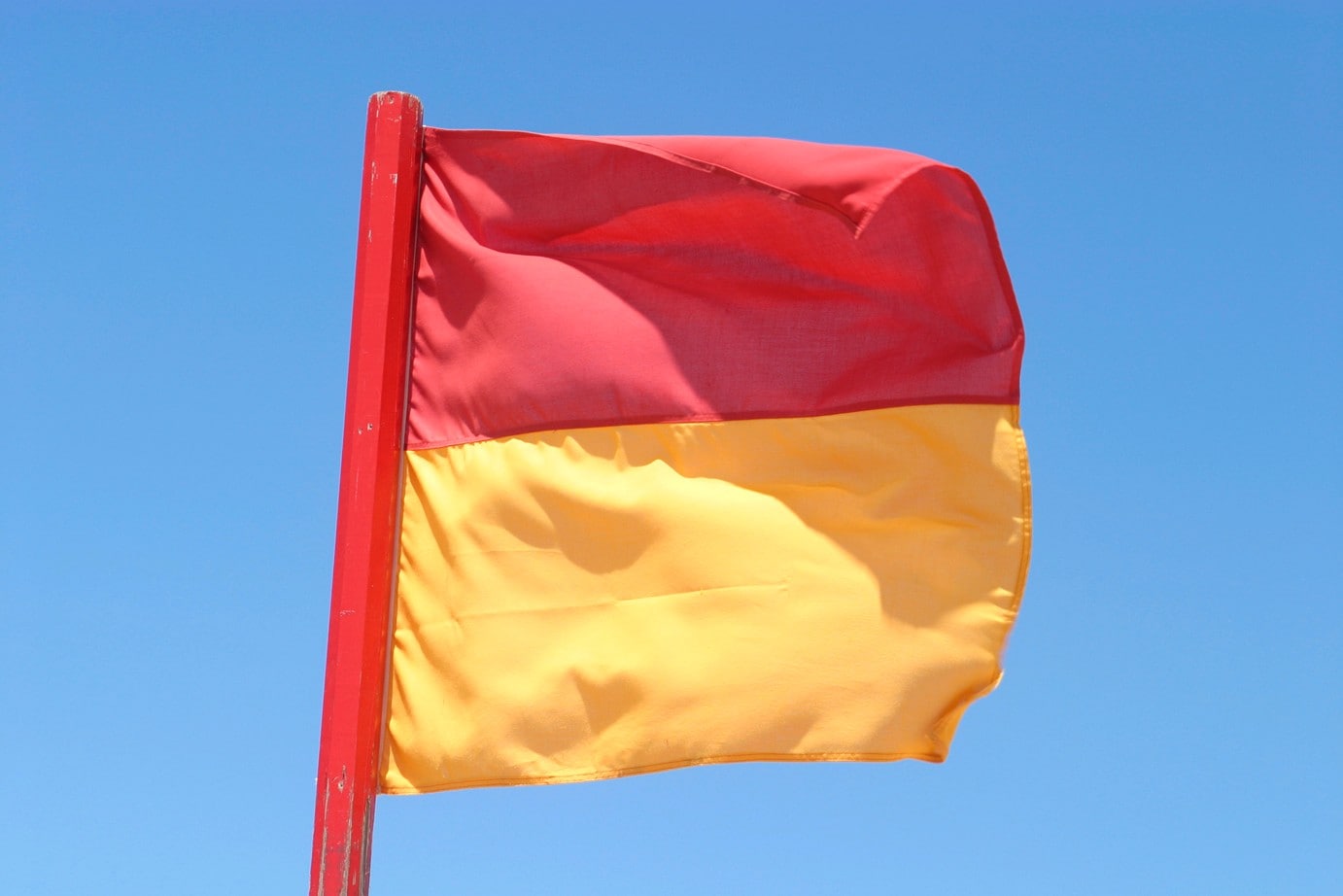 Red and yellow surf lifesaver flag © Surf Life Saving Australia