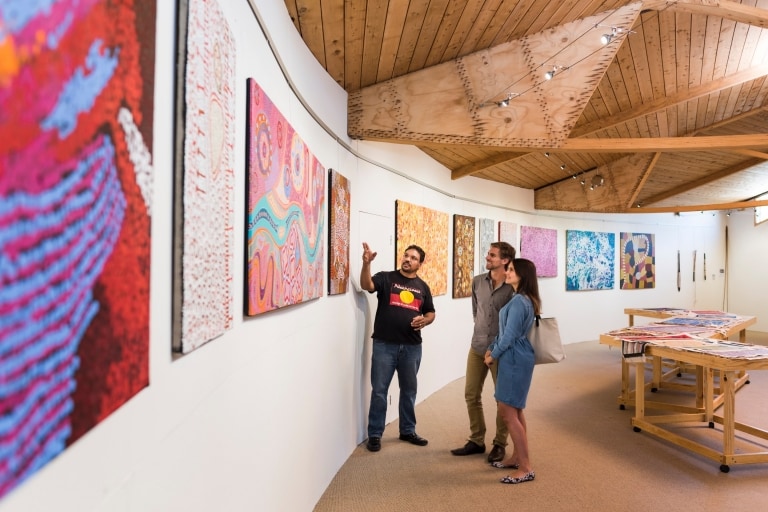 Two people wandering an Aboriginal art gallery with a guide at Narana Aboriginal Cultural Centre, Geelong, Victoria © Rob Blackburn
