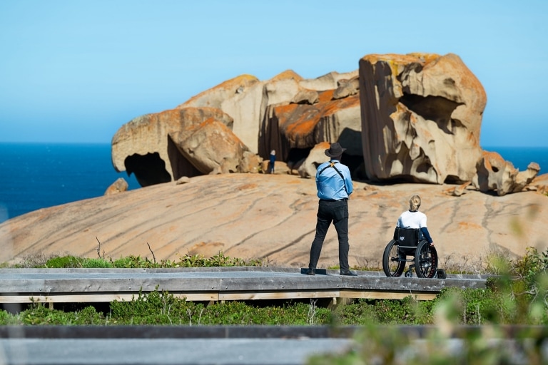 Two people gaze at the Remarkable Rocks, Kangaroo Island, South Australia © Tourism Australia