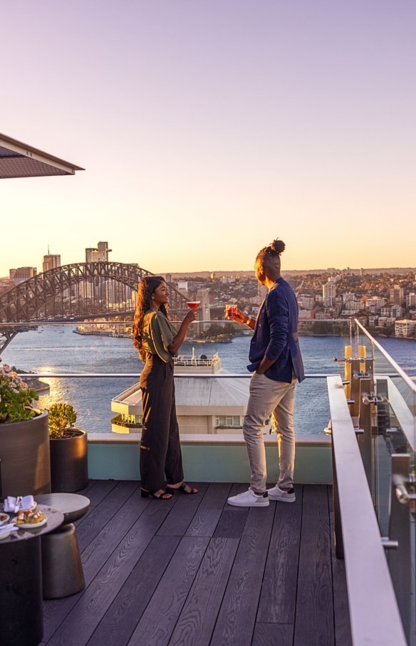 Aster Bar rooftop bar overlooking Harbour Bridge and Opera House, Sydney, New South Wales © Tourism Australia
