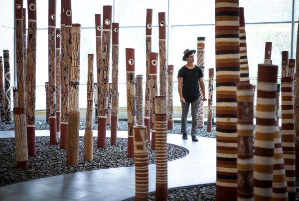 Man walking through an exhibit at the National Gallery of Australia in Canberra © Visit Canberra