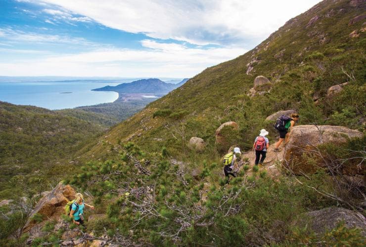 Woman walking the Freycinet Experience Walk in Freycinet National Park © Friendly Beaches Lodge / Great Walks of Australia