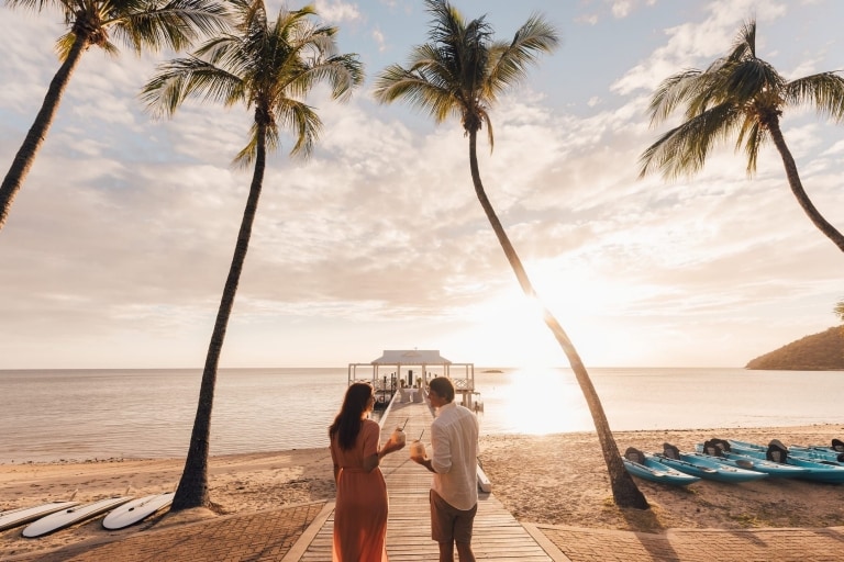 Couple enjoying cocktails on the pier at Orpheus Island Lodge, Great Barrier Reef, Queensland © Tourism and Events Queensland