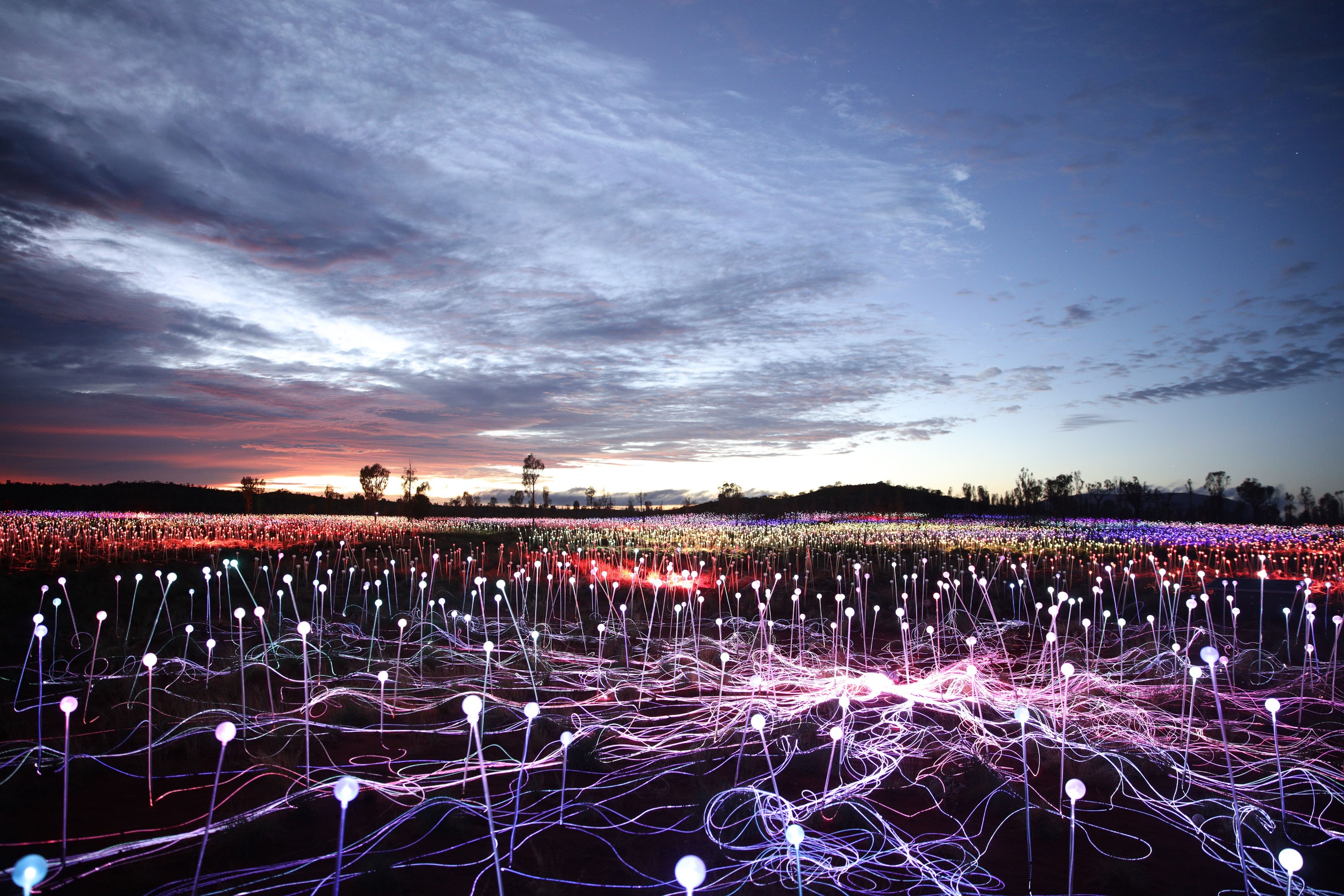 Multi-coloured stem lights illuminate the Field of Light Uluru by Bruce Munro in Yulara © Voyages Marketing