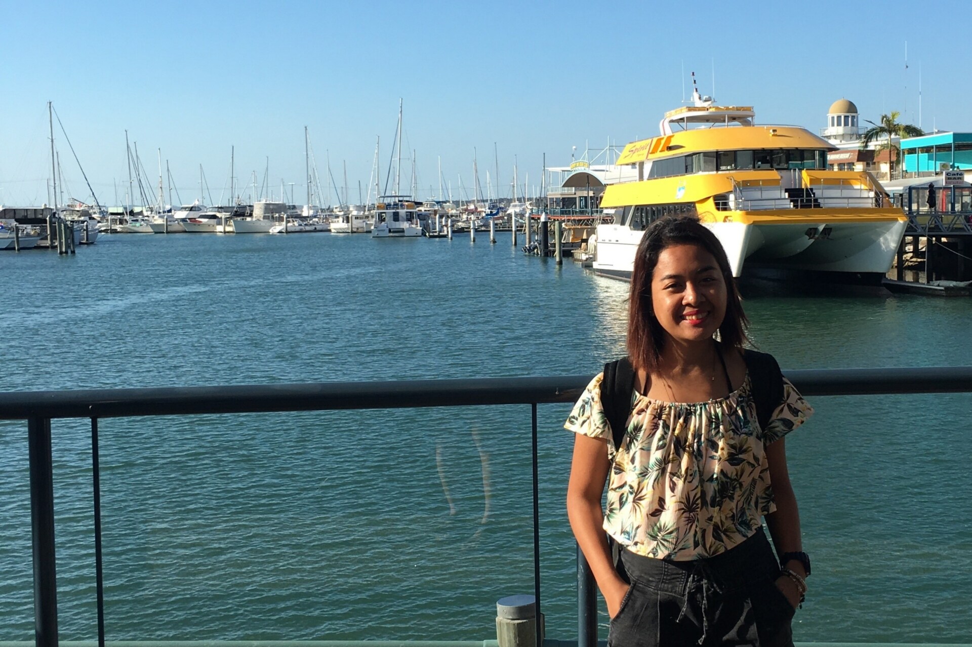 Maria Karla Cervantes from Chan Brothers posing at Hervey Bay Marina, before her whale-watching encounter.