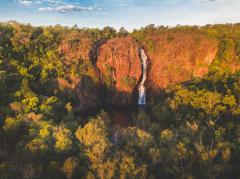 An aerial view of Wangi Falls against a red rock cliff in Litchfield National Park © Tourism NT/Dan Moore