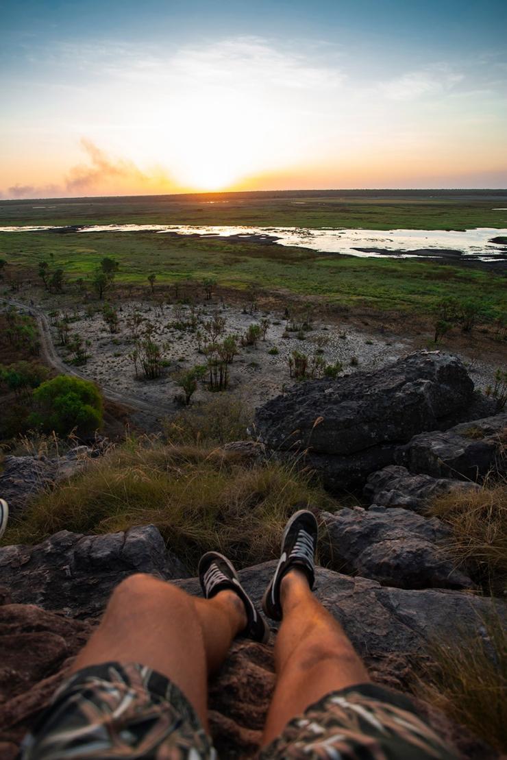 Man relaxing at sunset, Ubirr, Kakadu, NT © Tourism Australia