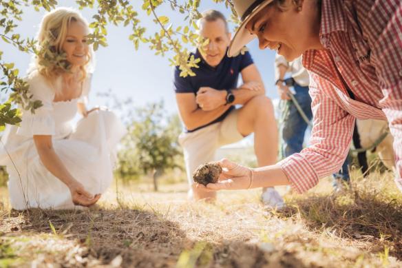 A farmer harvests a truffle and shows it to guests at The Folly Truffles, Queensland Country, Queensland © Tourism and Events Queensland