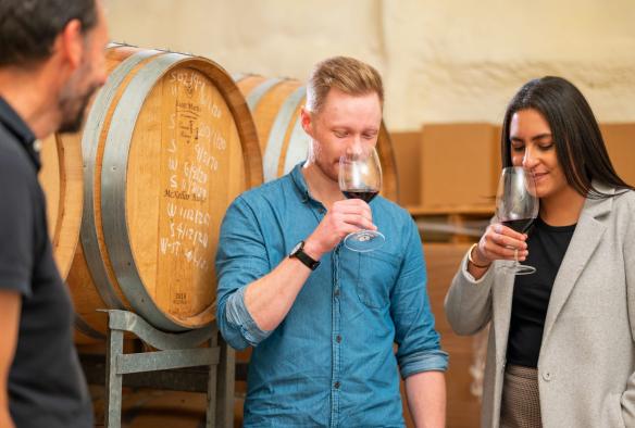 Two guests, part of the Van Du Vin tour group, are pictured sniffing glasses of red wine, Canberra, Australian Capital Territory © Tourism Australia 