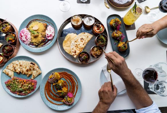 Aerial of a dining table with a variety of dishes available, Darwin Gourmet Tour, Darwin, Northern Territory © Tourism Australia