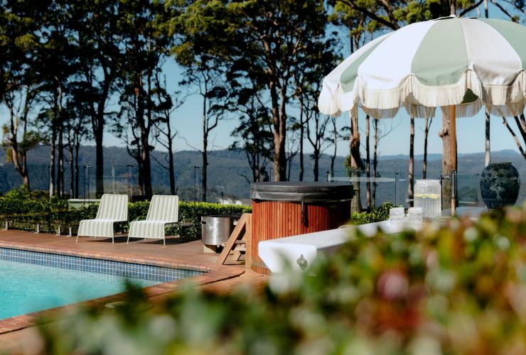 A pool with outdoor chairs and an umbrella at Verandah House Country Estate, Tamborine Mountain, Queensland © Verandah House Country Estate