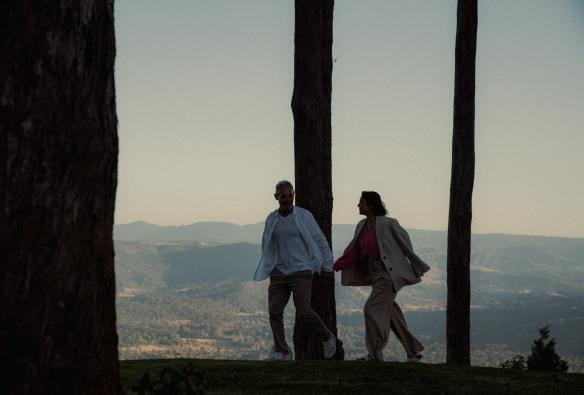 A man and woman walking amongst trees, Tamborine Mountain, Queensland © Reveling