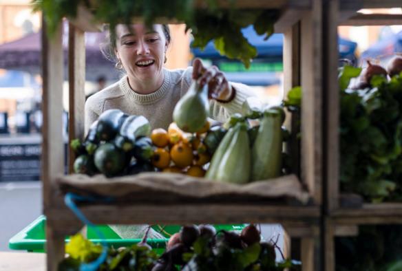 Woman selecting fresh vegetables at Harvest Market, Launceston, Tasmania © Tourism Australia
