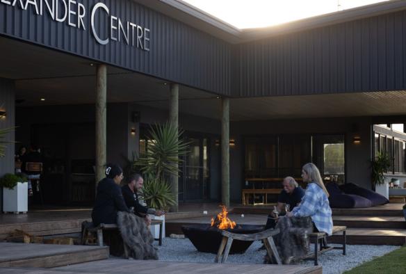 Guests gathered around the firepit, The Cove, North West Tasmania, Tasmania © Jess Bonde