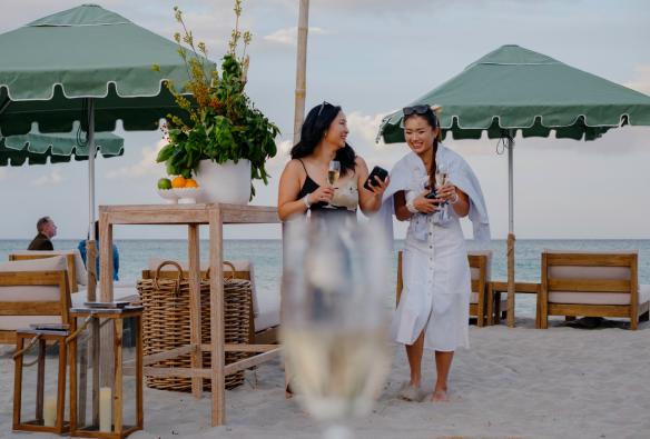 Women walk along the beach with glasses of wine at Pair’d Margaret River, Australia’s South West, Western Australia © Tourism Western Australia