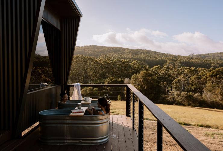 Couple bathing in outdoor baths at Heyscapes Cabin, Denmark, Western Australia © Joia Ellery & Adan Kenna