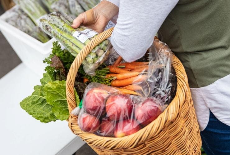 Woman buying fresh produce at Albany Farmers Market, Western Australia © Tourism Australia