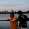 A man and woman admiring the distant view of the city from St Kilda Pier, Melbourne, Victoria © Visit Victoria