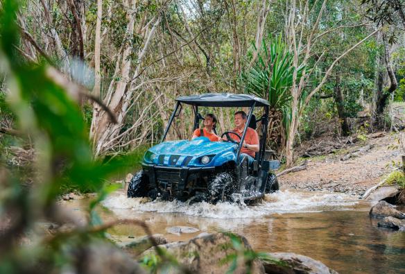 Two people driving around Kur-Cow Barnwell Farm on a self-guided ATV tour, Kuranda, Queensland © Tourism and Events Queensland