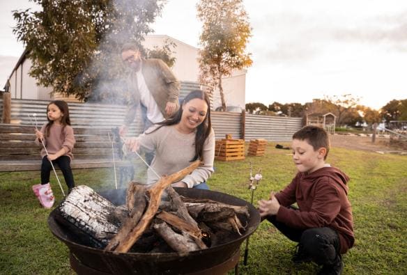 Family roasting marshmallows over a bonfire at Redwing Farm, Yorke Peninsula, South Australia © Tourism Australia