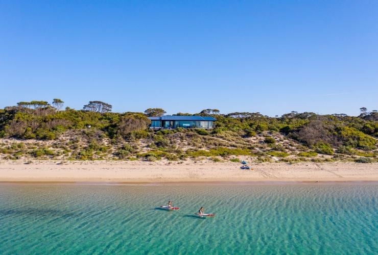 Two people kayaking in the ocean near beachfront accommodation, One Kangaroo Island, Kangaroo Island, South Australia © South Australian Tourism Commission