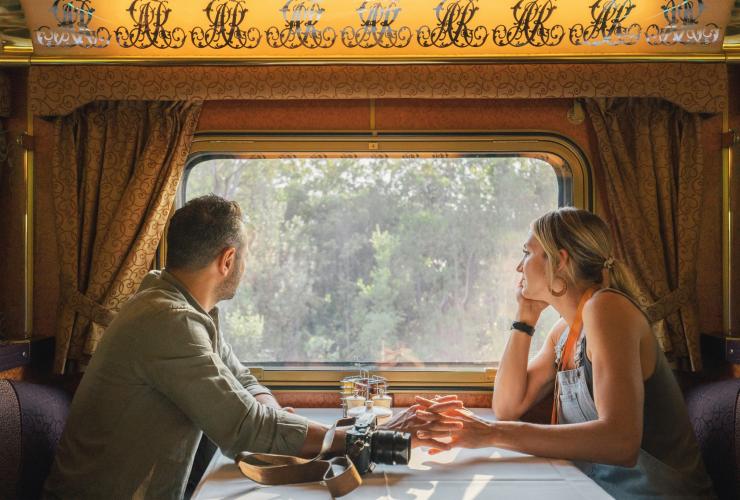 Couple looking out the window aboard the Great Southern train © Journey Beyond Rail Expeditions