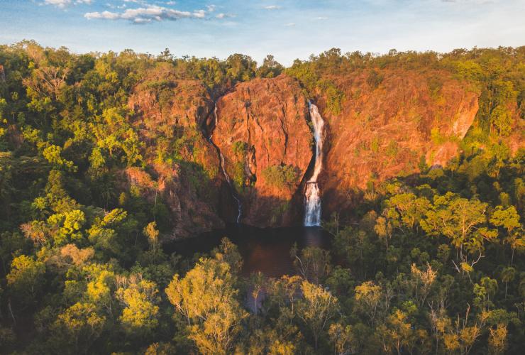 A person on an inflatable ring in a waterhole with waterfalls, Wangi Falls, Litchfield National Park, Northern Territory © Tourism NT