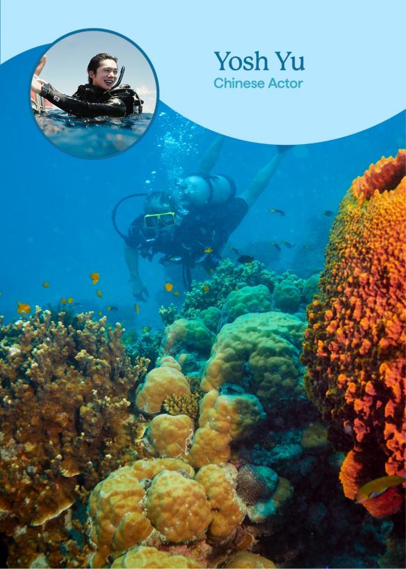 A person scuba diving among colourful coal and fish, with an image overlaid of a man smiling with the caption "Yosh YU, Chinese Actor".