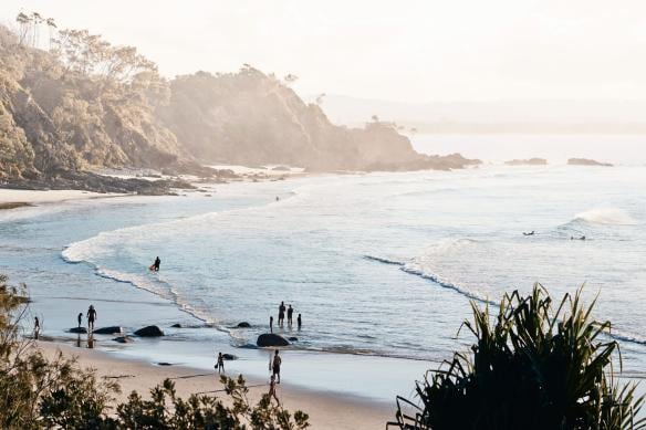 View of the rocky coast and sandy beach at Byron Bay, New South Wales © Tourism Australia
