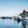 Blue boats sitting on the calm water of Hobart Harbour in Hobart, Tasmania © Adam Gibson