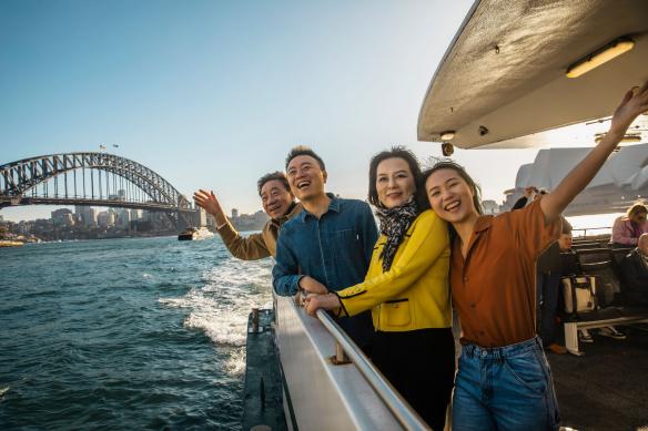 Family enjoying harbour views on board the Sydney Harbour Ferry, Sydney, New South Wales © Destination NSW