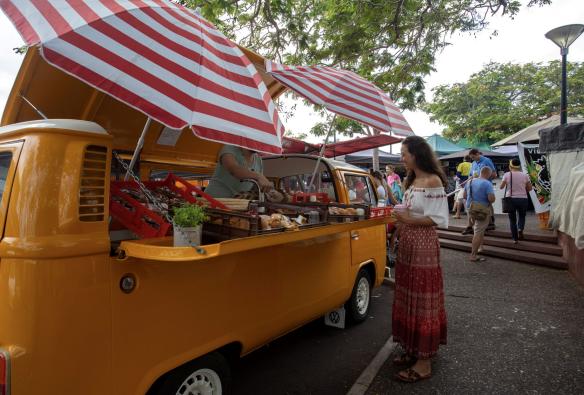 Woman stopped at a food vendor at the Parap Markets, Darwin, Northern Territory © Tourism Australia