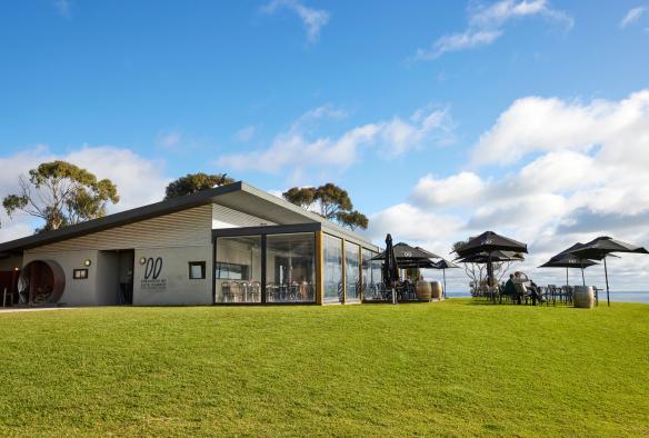 On a large patch of bright green grass, overlooking the bay in Bellarine, sits a smartly designed cellar door for Jack Rabbit winery, Geelong and the Bellarine, Victoria © Tourism Australia