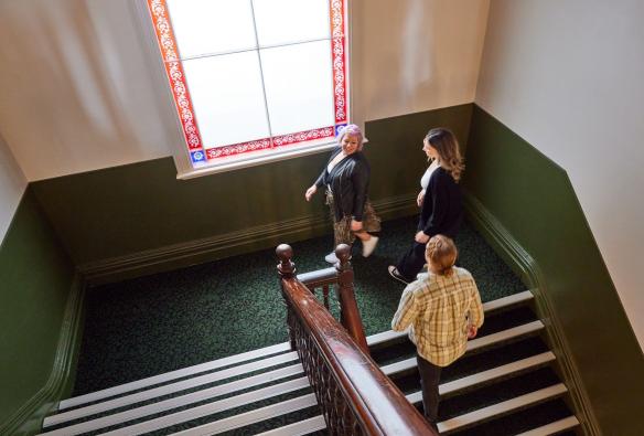 Overhead shot of guests walking up a staircase from the bar to the hotel rooms, Portarlington Grand Hotel, Geelong and the Bellarine, Victoria © Tourism Australia