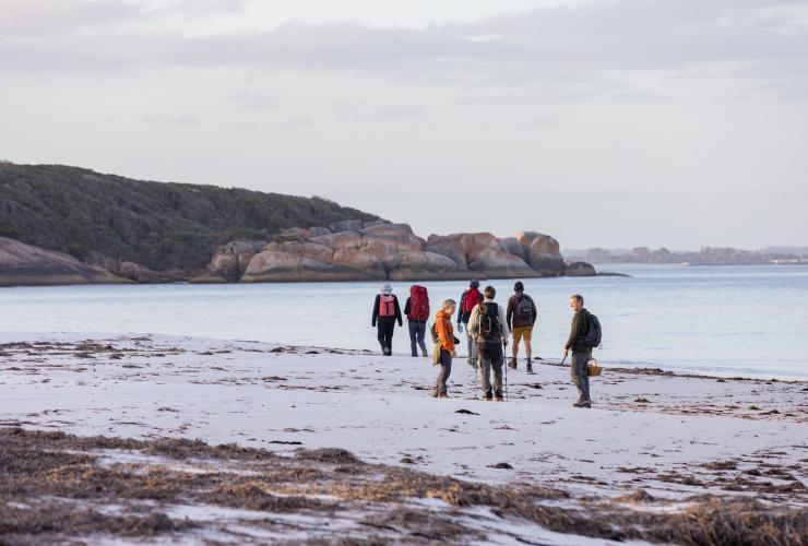 Group hiking on the beach in Albany, Western Australia © Susan McCabe t/as Busy Blue Bus Tours