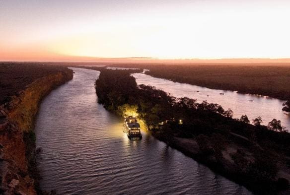 An aerial view of the Murray Princess boat floating down the Murray River at dusk, South Australia © Tourism Australia