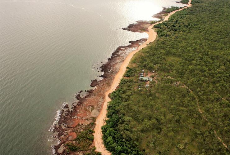 Aerial view over a fishing lodge on a rugged coastline surrounded by bushland, Dhipirri Barra & Sportfishing, Arnhem Land, Northern Territory © Dhipirri Barra & Sportfishing