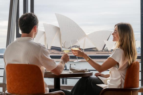 Couple enjoying white wine with a view of the Sydney Opera House at The Oriana, Sydney, New South Wales © The Oriana
