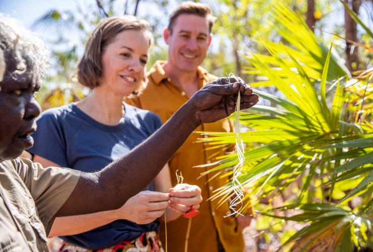 A couple learning about the uses of native plants with an Aboriginal Guide, Animal Tracks Safari, Kakadu National Park, Northern Territory © Tourism NT/Helen Orr
