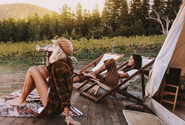 Two people relaxing on a balcony, sipping wine beside a vineyard, Cubby and Co, Mount Majura Vineyard, Australian Capital Territory © Cubby and Co/ Shan Bawden