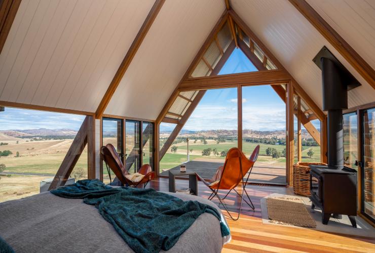 Interior of a tiny home with a balcony overlooking rolling hills, Kimo Estate, Gundagai, New South Wales © Kimo Estate/Matt Beaver Photography